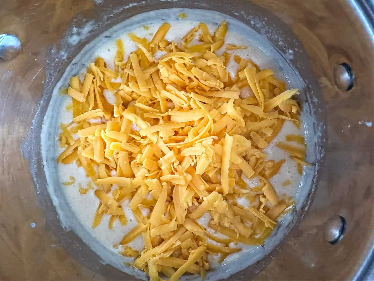 shredded cheese in a pot with a flour and butter roux