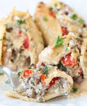 fork on a plate with a bite of cheesesteak stuffed shells