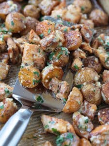 spatula with garlic parmesan chicken and potatoes