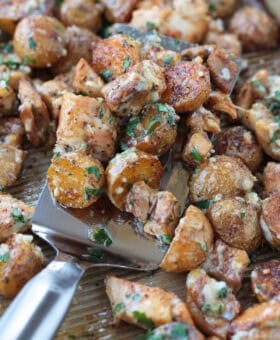 spatula with garlic parmesan chicken and potatoes