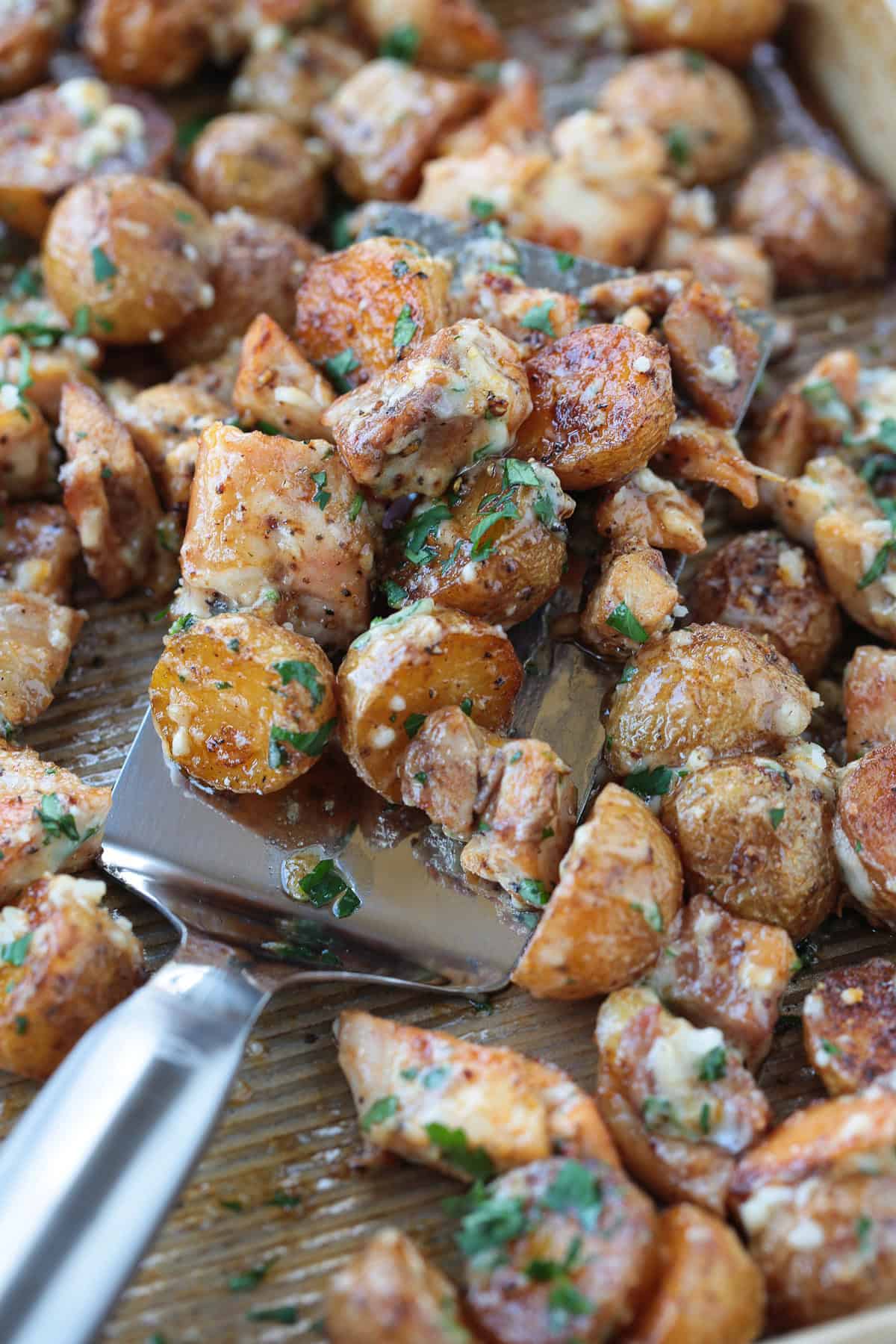 spatula with garlic parmesan chicken and potatoes