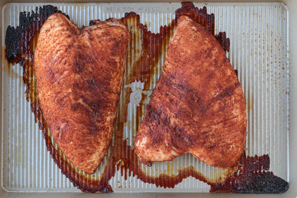 Skip the deli and make our Homemade Turkey Deli Meat instead! Not only is it super flavorful, it's less expensive and better for you, too! seasoned, cooked turkey tenderloins on baking sheet