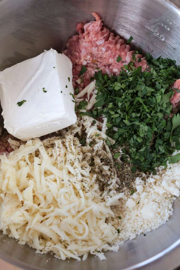 bowl with italian sausage, cream cheese, and other ingredients for making sausage crostini