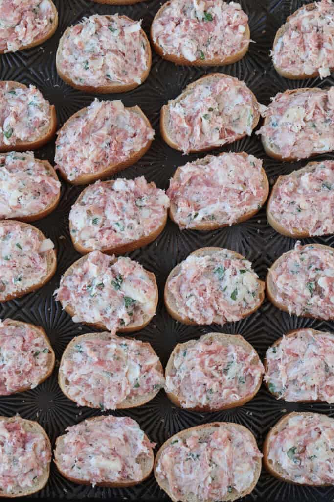 sausage and cheese mixture spread onto slices of bread