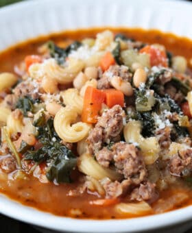 side view of a bowl of minestrone soup with sausage