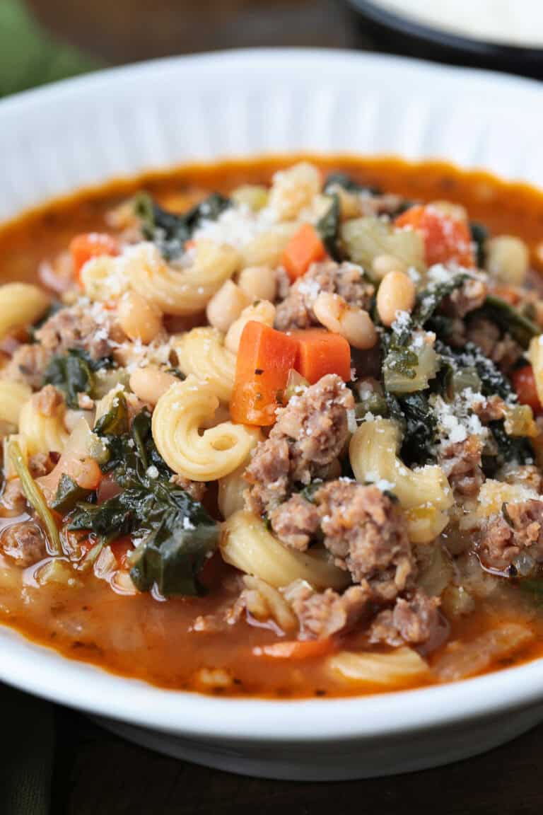 side view of a bowl of minestrone soup with sausage