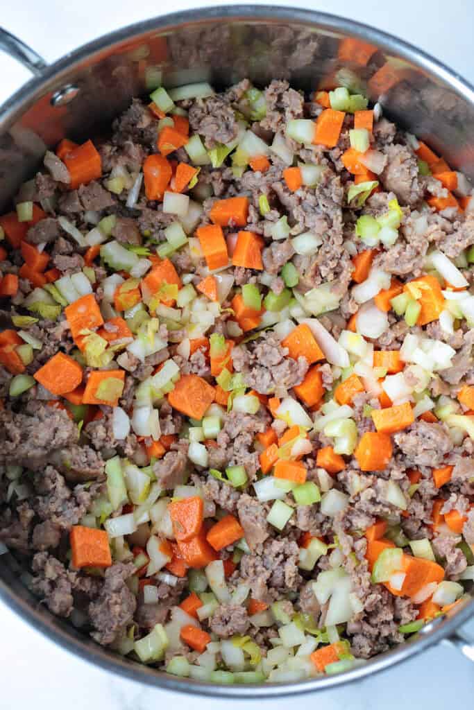 sausage and vegetables in a pot for making soup