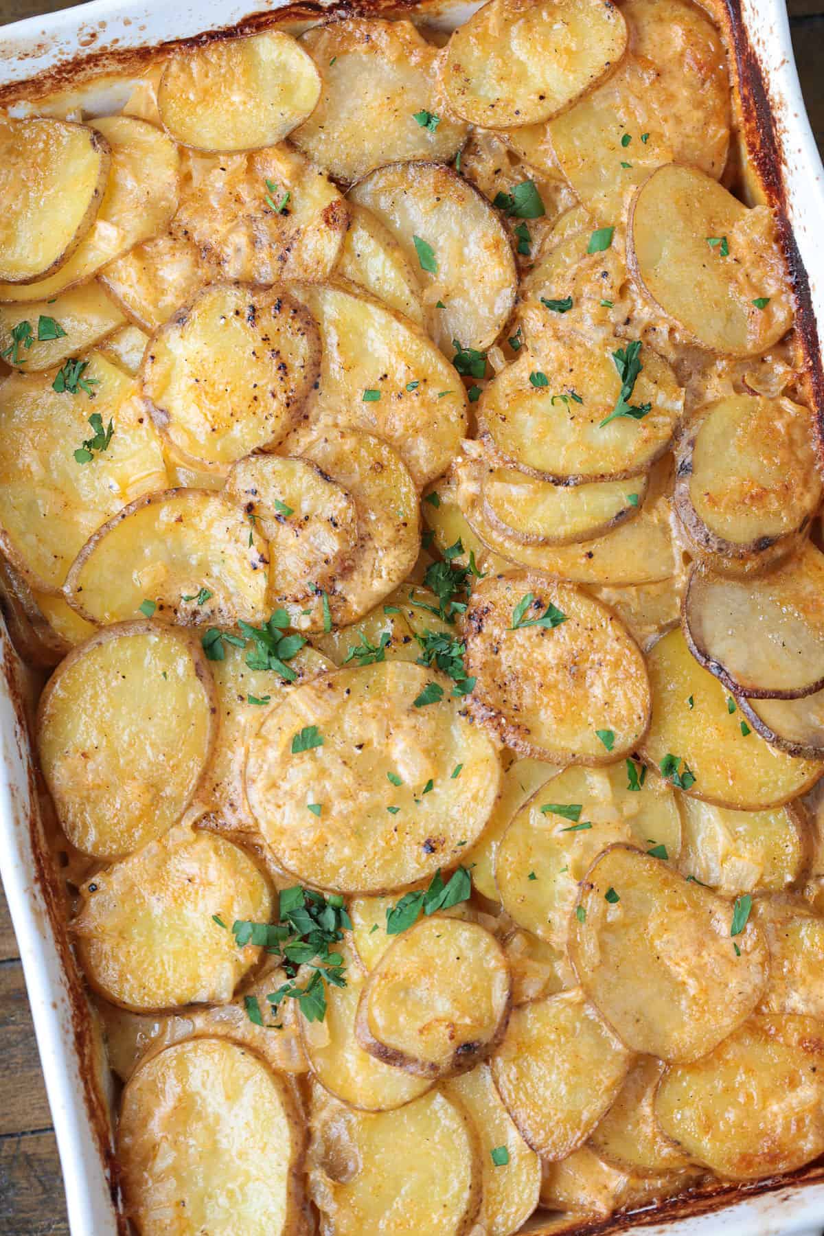 cooked cheesy potato casserole in baking dish