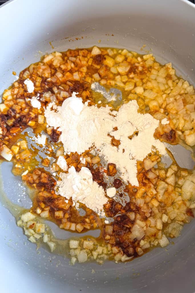 cooked onions in a skillet with seasonings and flour