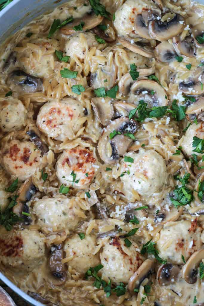skillet with mushroom orzo and chicken meatballs