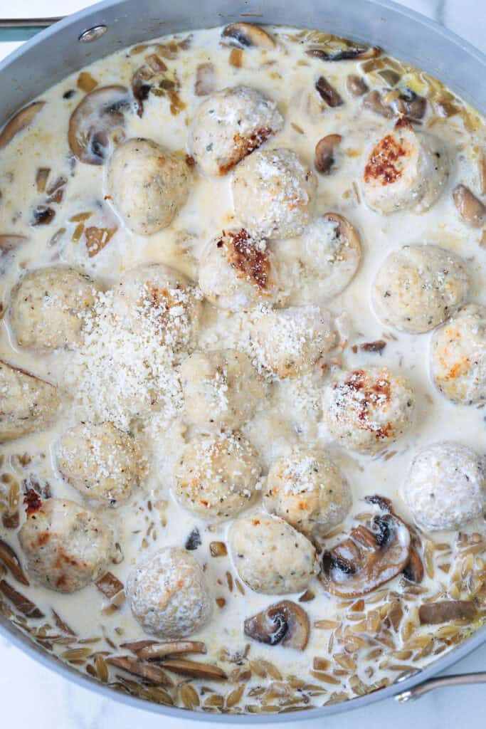 chicken meatballs in a skillet with cream