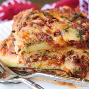slice of zucchini lasagna on plate with text