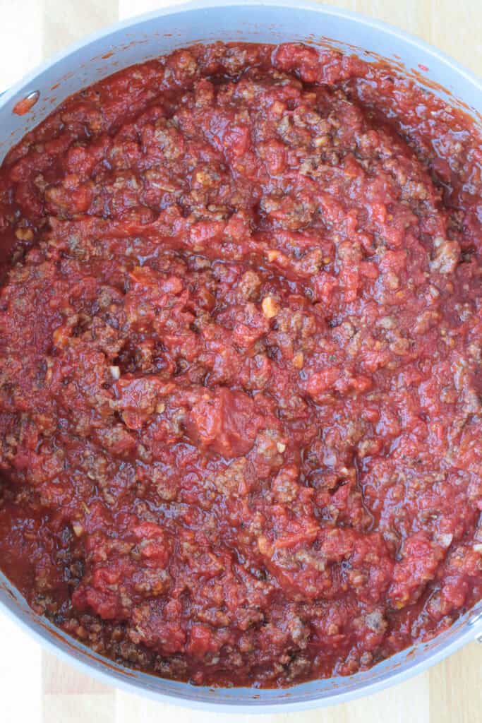 Our Fool Proof Zucchini Lasagna turns out perfect every time. Thin strips of zucchini make a lighter lasagna recipe with tons of flavor! tomato meat sauce in a skillet