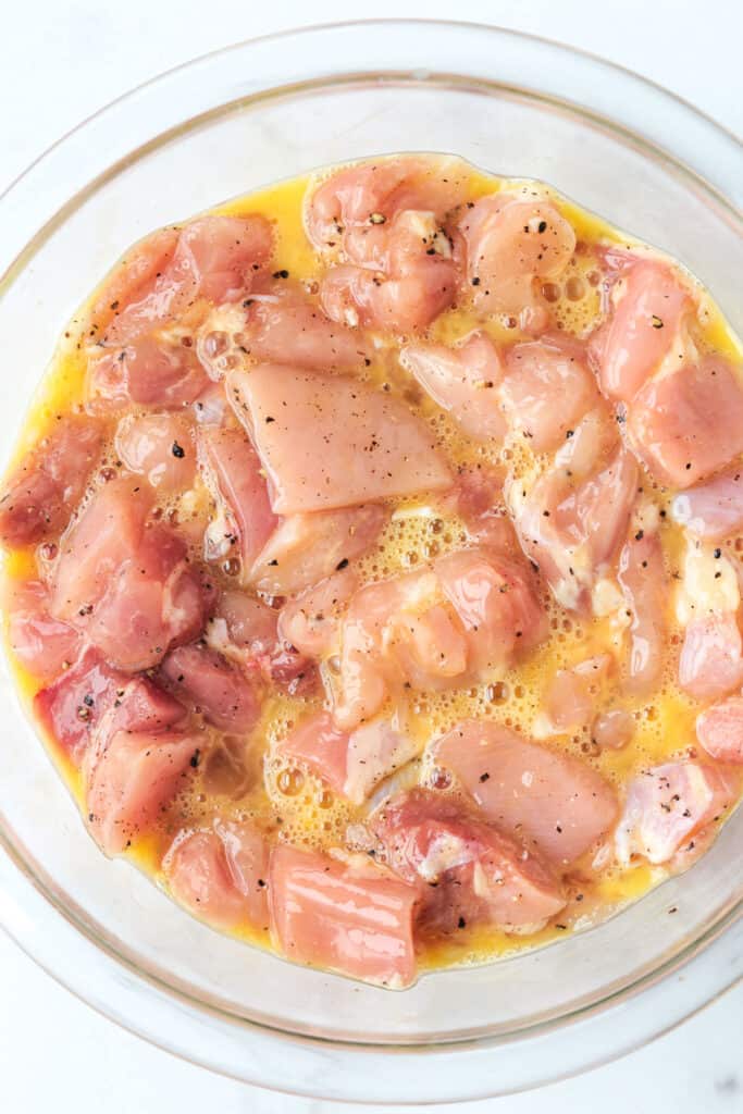 cubed chicken in a bowl with egg