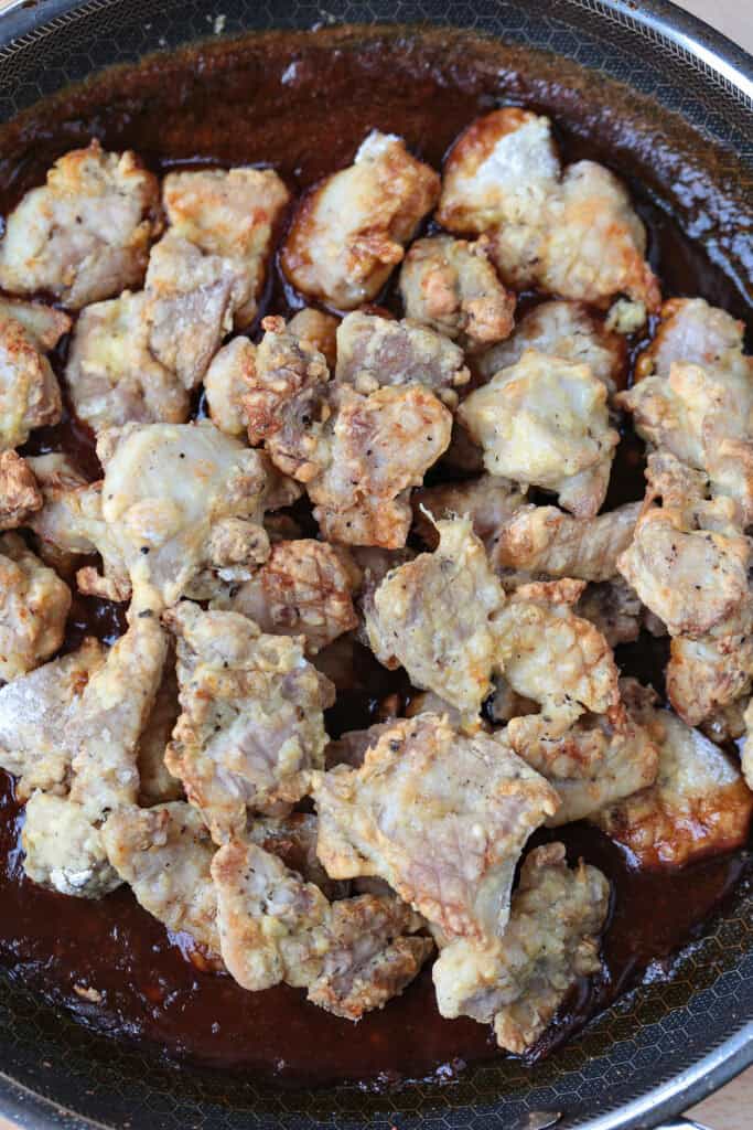 Air Fryer General Tso's Chicken is a lighter take on the take-out recipe that you'll love. The same flavors you crave but without the oil. air fried chicken in skillet with sauce