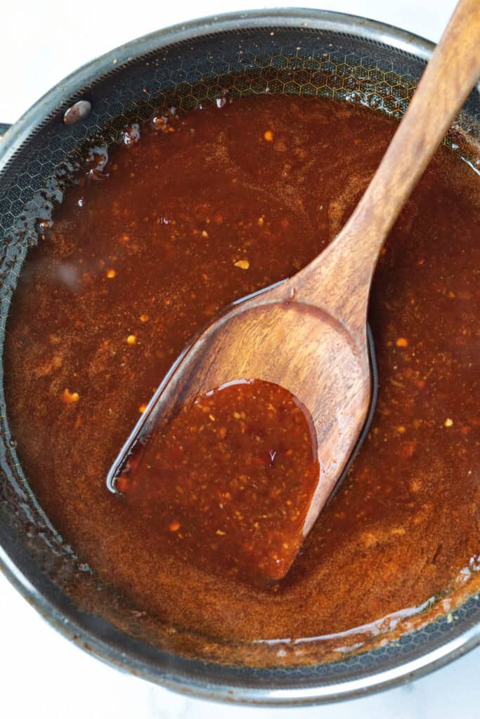 Air Fryer General Tso's Chicken is a lighter take on the take-out recipe that you'll love. The same flavors you crave but without the oil. sauce for general tso's chicken in skillet with spatula