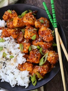 general tsos chicken with rice and chopsticks
