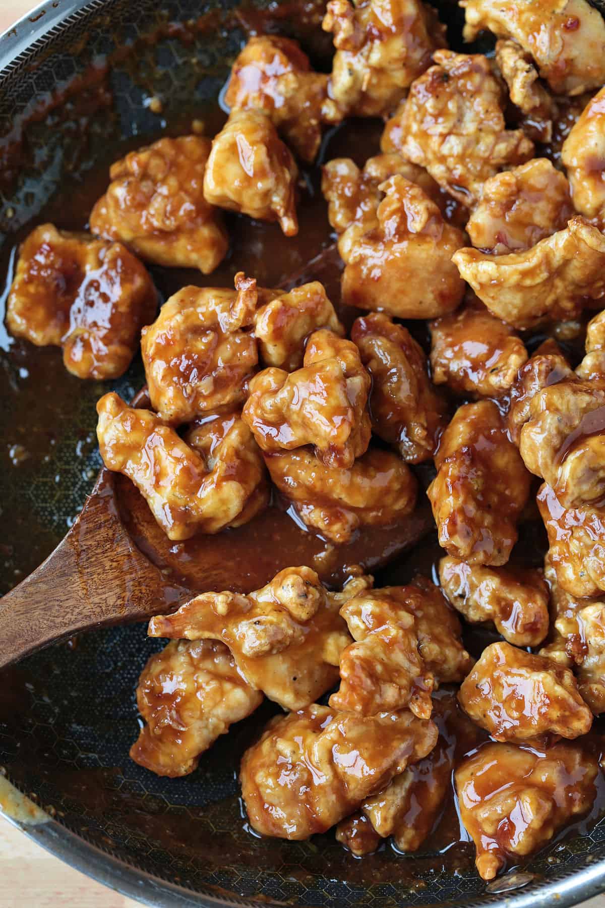 Air Fryer General Tso's Chicken is a lighter take on the take-out recipe that you'll love. The same flavors you crave but without the oil. skillet with general tso's chicken and spatula