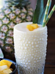 pineapple smoothie with pineapple in background