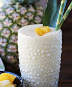 pineapple smoothie with pineapple in background