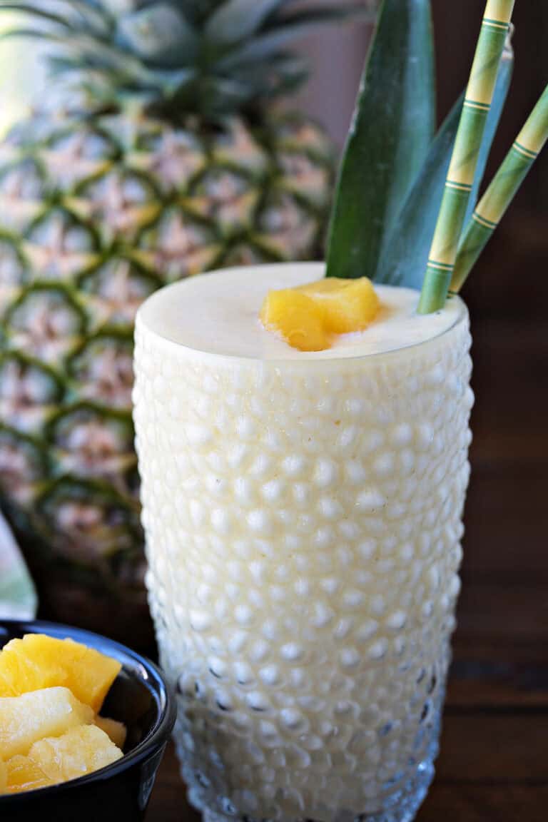 pineapple smoothie with pineapple in background