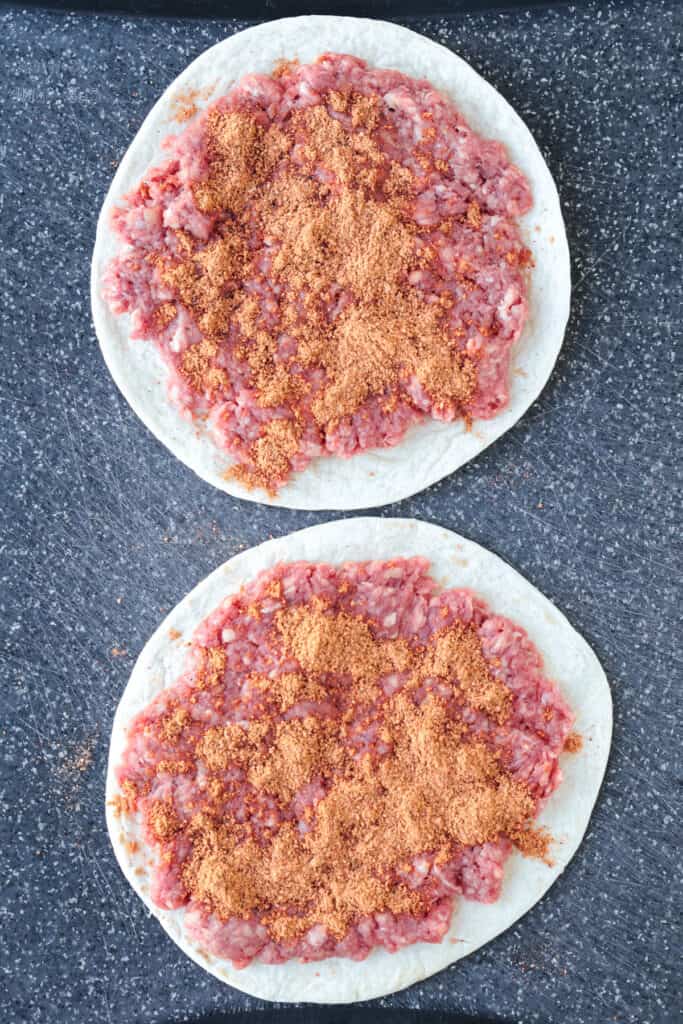 Smash Tacos are the key to fun dinners that everyone loves. Seasoned ground beef cooked on a crispy tortilla with your favorite toppings! ground beef and seasoning spread on tortillas