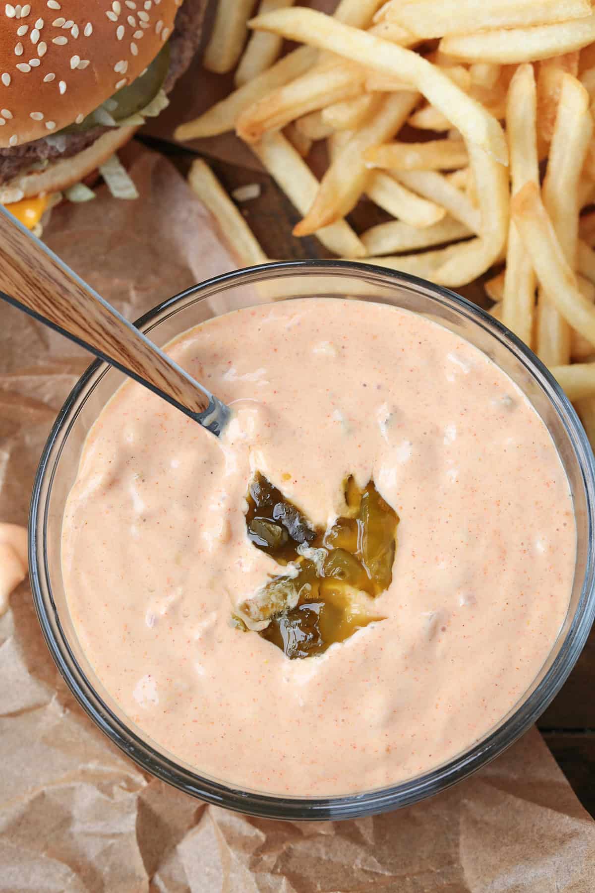 copycat big mac sauce in a bowl with big macs and fries on the side