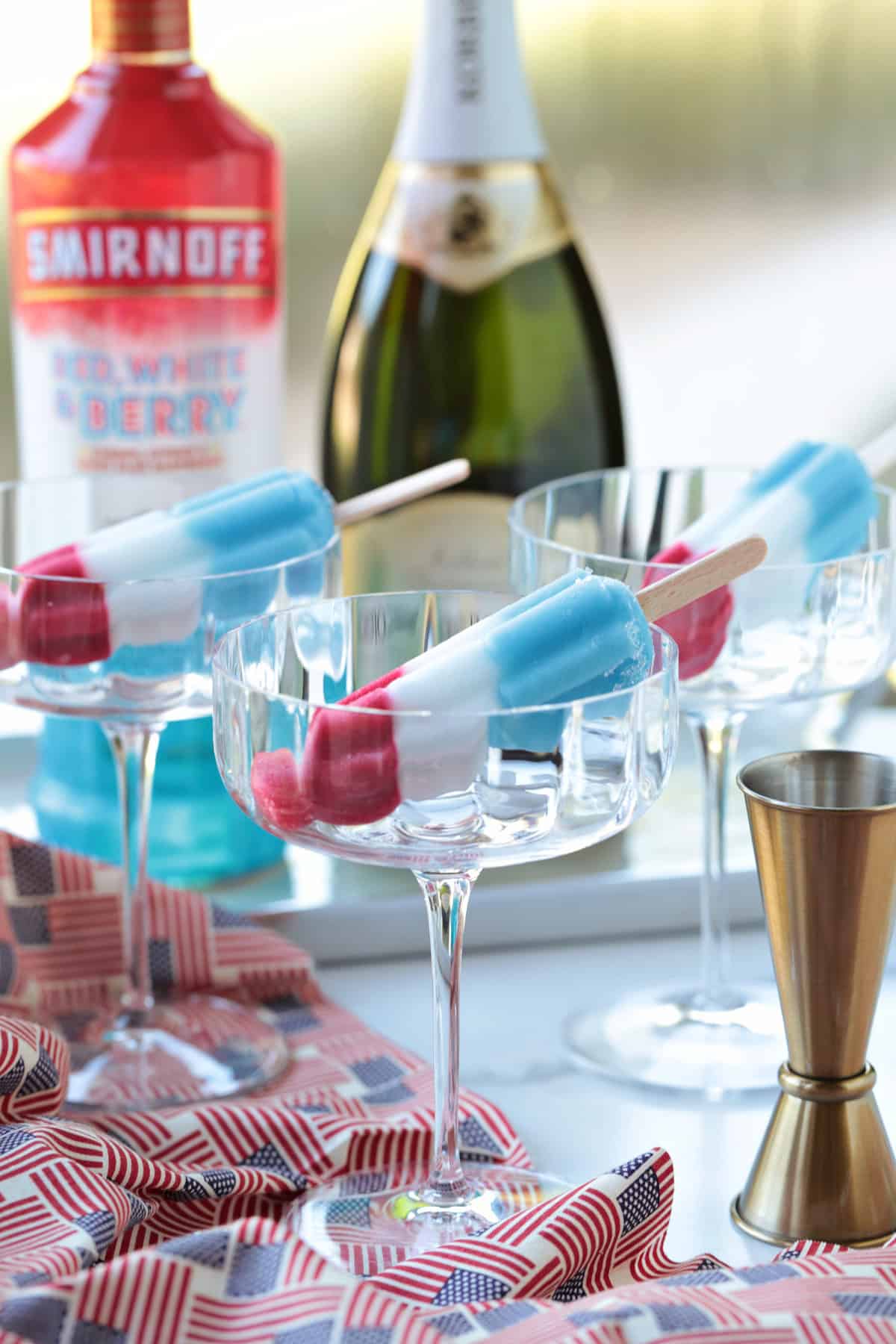 This Bomb Pop Cocktail is the easiest summer drink you'll ever make! The popsicle melts into the champagne for added fun and flavor! ingredients for making bomb pop champagne