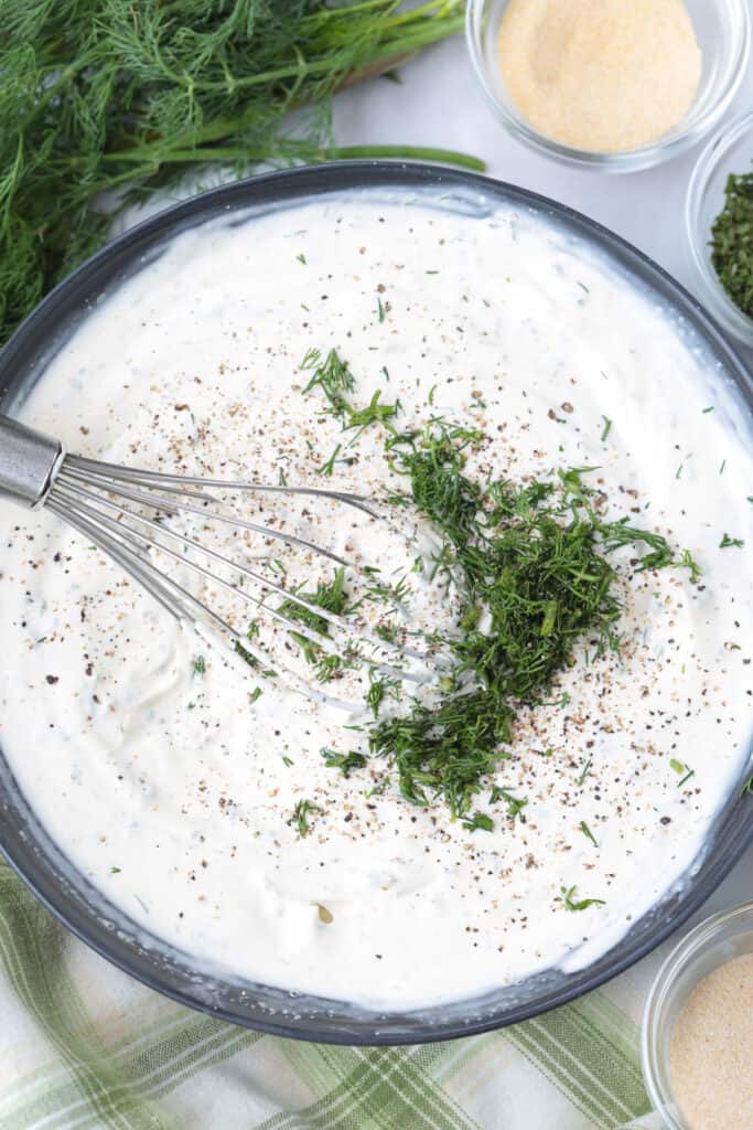 One taste of our Homemade Ranch Dip and you won't go back to store bought! Just five minutes to make – it's fresh and herby and so addicting. ranch dip in a bowl with whisk