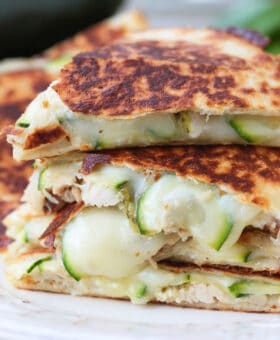 chicken quesadillas with sliced zucchini stacked on a plate