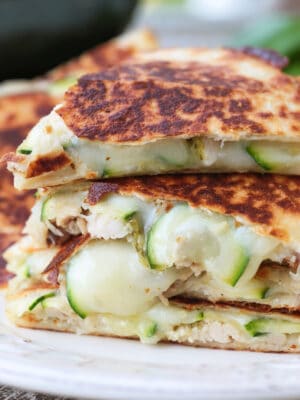 chicken quesadillas with sliced zucchini stacked on a plate
