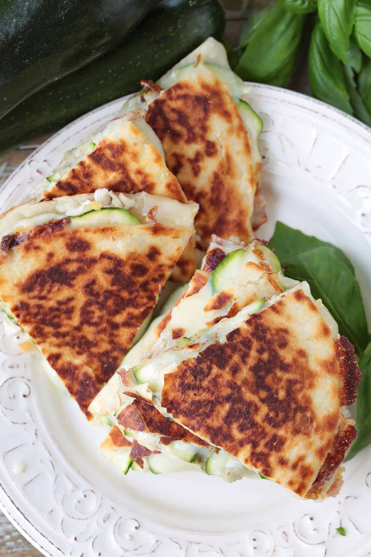 Crispy Chicken Zucchini Quesadillas are filled with tender chicken, thinly sliced zucchini and gooey cheese for an easy 30 minute dinner. top view of chicken zucchini quesadillas on a plate