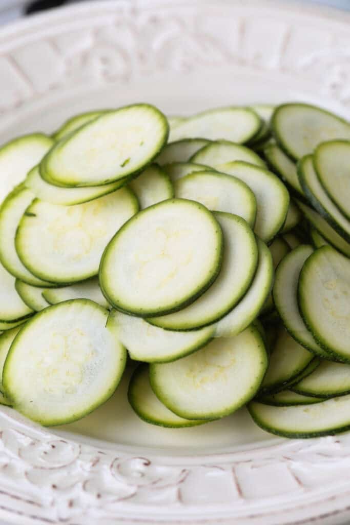 Crispy Chicken Zucchini Quesadillas are filled with tender chicken, thinly sliced zucchini and gooey cheese for an easy 30 minute dinner. thinly sliced zucchini on a plate