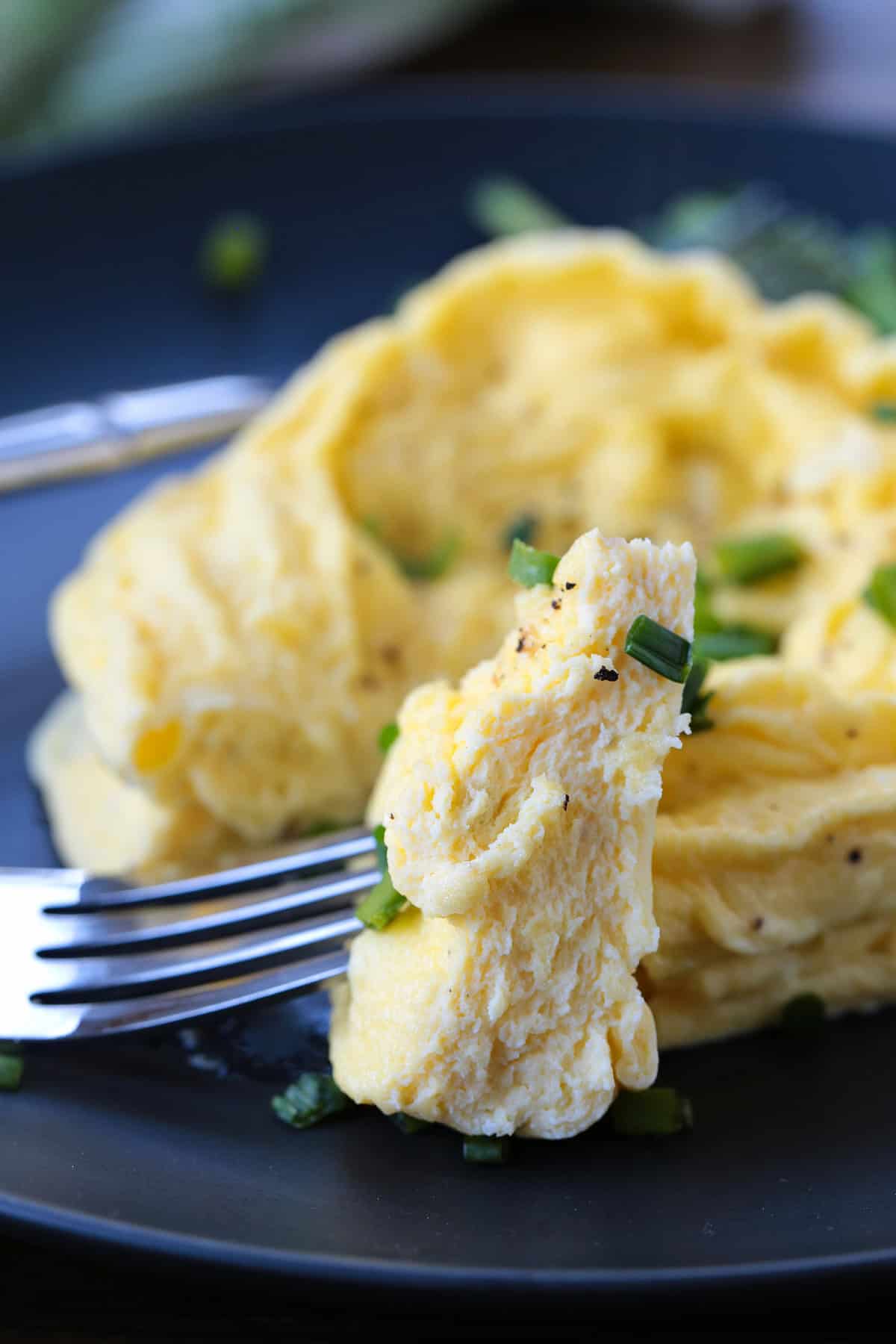 fork with a bite of microwave scrambled eggs