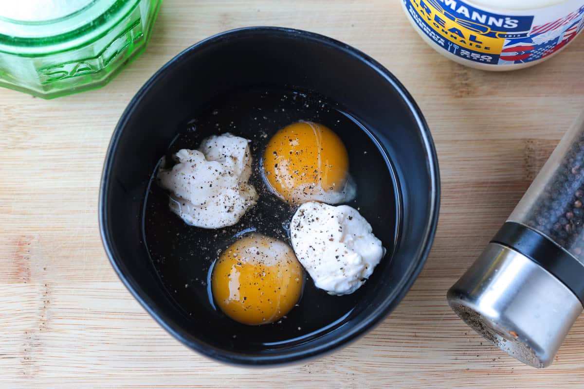 eggs and mayonnaise in a black dish