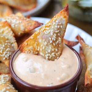 cheeseburger wonton dipping into big mac sauce
