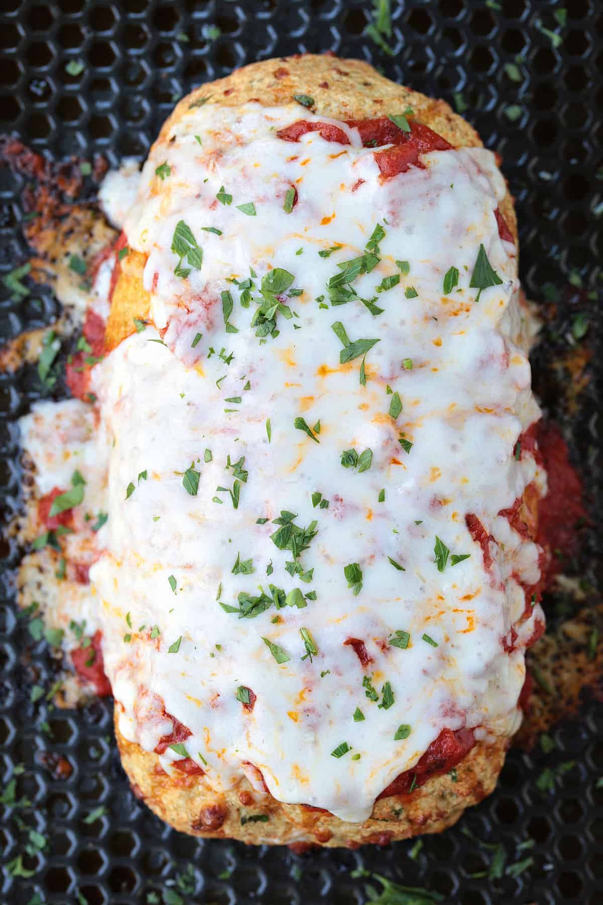 Chicken Parmesan Meatloaf has all the flavors of the classic dish. Juicy and flavorful meatloaf smothered with sauce and mozzarella cheese! chicken meatloaf topped with sauce and mozzarella cheese