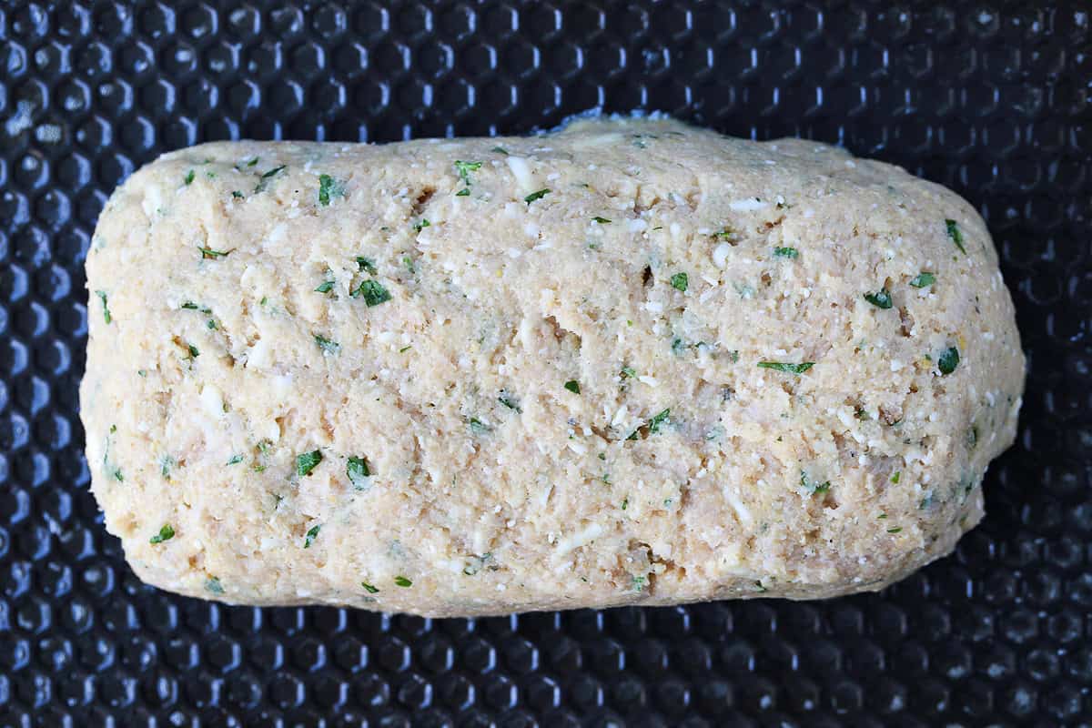 Chicken Parmesan Meatloaf has all the flavors of the classic dish. Juicy and flavorful meatloaf smothered with sauce and mozzarella cheese! uncooked chicken meatloaf on baking sheet