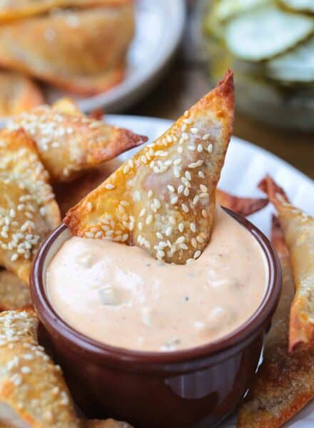 cheeseburger wonton dipping in big mac sauce