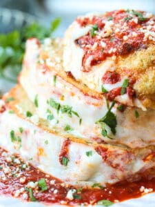 chicke parmesan meatloaf sliced and stacked on a white plate