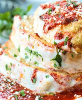 chicke parmesan meatloaf sliced and stacked on a white plate