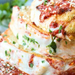 chicke parmesan meatloaf sliced and stacked on a white plate