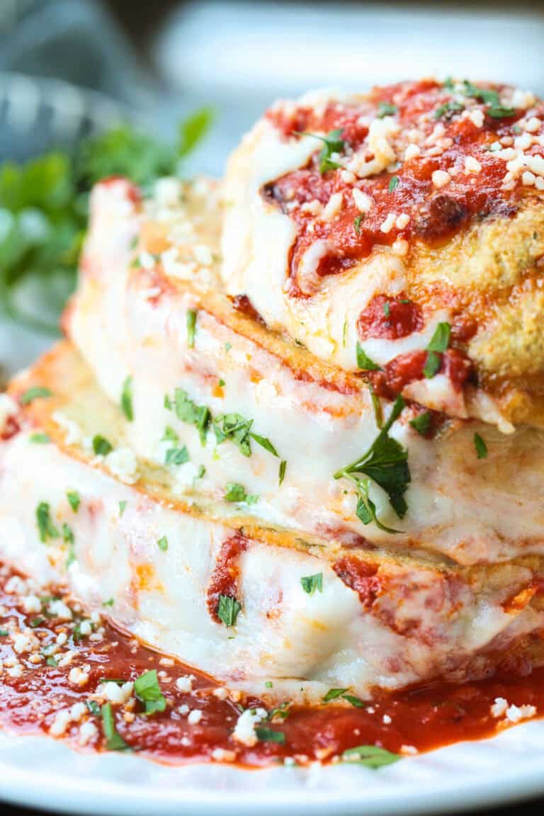 chicke parmesan meatloaf sliced and stacked on a white plate