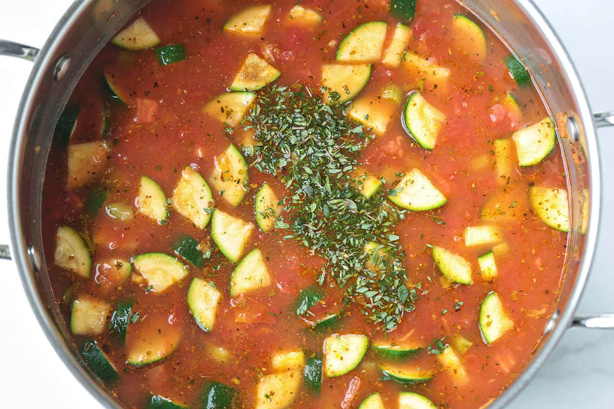 minestrone soup in a pot with dried herbs