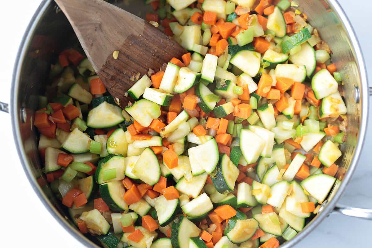 vegetables in a pot with wooden spoon