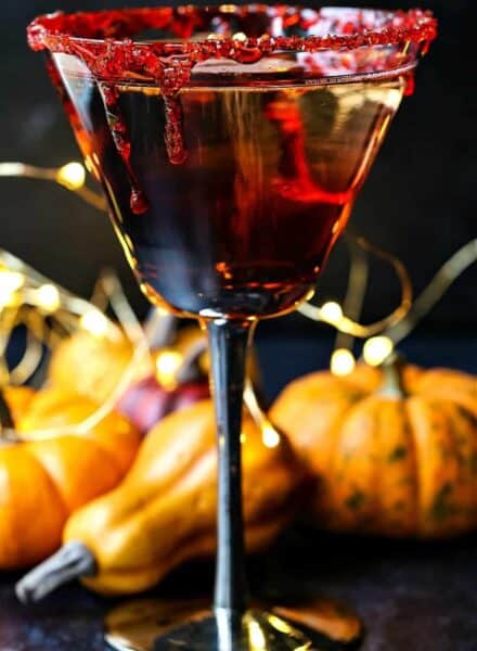 red martini with fake blood dripping down sides of glass